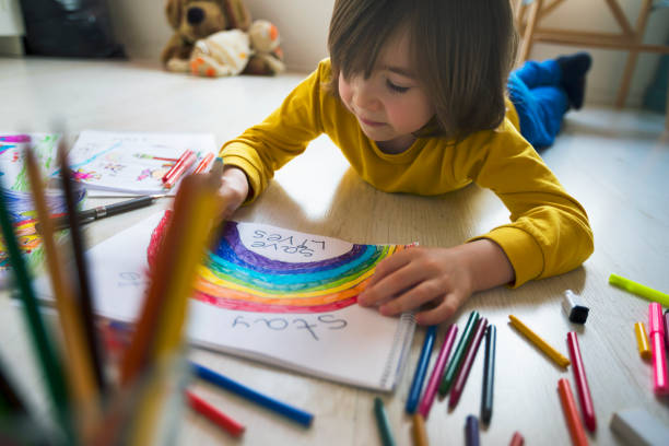 istock Happy boy drawing rainbow at home. 1223048649