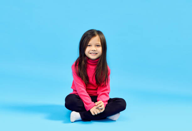 istock Sweet little girl posing over blue background 1223049050