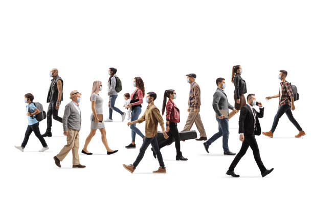 istock People wearing protective face masks and walking in different directions 1223049157