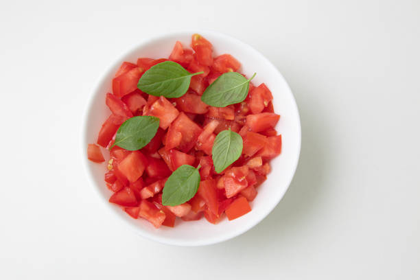 istock Chopped or Diced Tomatoes in a bowl with basil 1223049525
