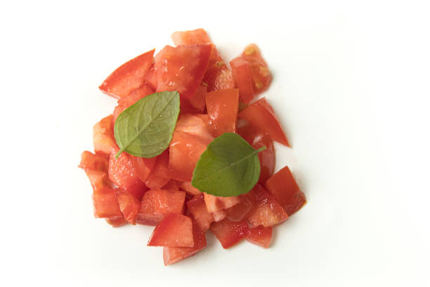 Heap of Chopped or Diced Tomatoes with basil isolated