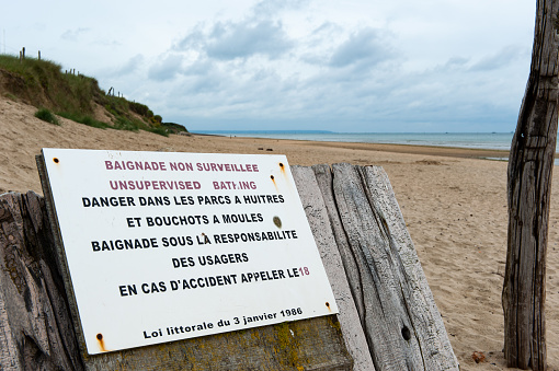 A sign on Utah Beach warns that the beach is non supervised, bathing is at one's own risk and the oyster and mussel banks are a dangerous area.