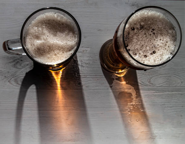 Two glasses of beer with a top view with a decorative falling shadow and orange light
