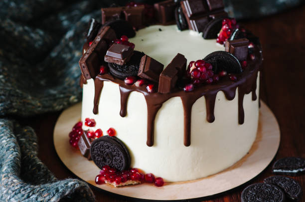 istock Cake decorated with chocolate drips, chocolate chips, pomegranate and chocolate chip cookies. 1223053455
