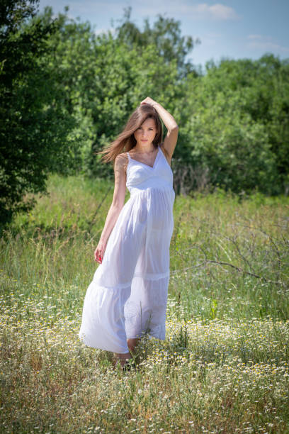 istock Young woman in white dress 1223053649