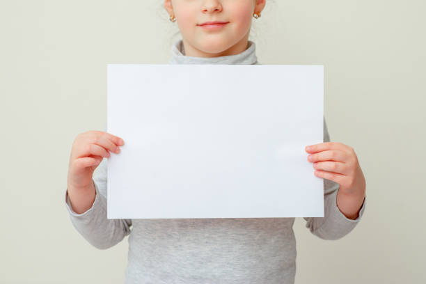 istock Mockup sheet of paper in child's hands. 1223055224