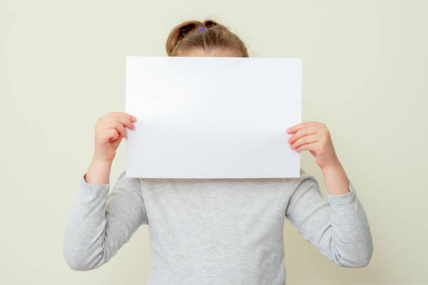 istock Mockup sheet of paper in child's hands. 1223055230