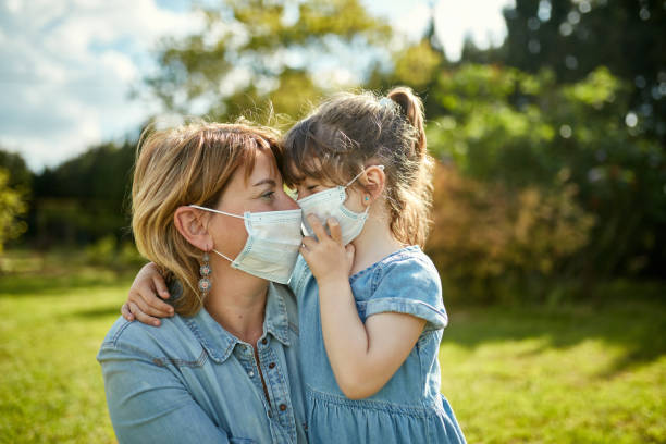 istock Responsible Mother and Young Daughter Wearing Face Masks 1223055450