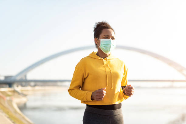 istock Woman running with protective face mask. 1223055471