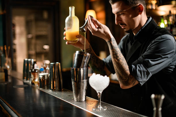 istock Male bartender prepares alcohol drink with jigger and shaker 1223055488