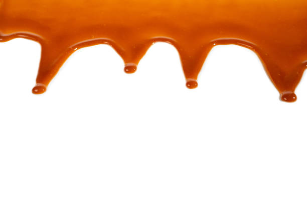 istock Background of flowing caramel sauce isolated on white. 1223056826
