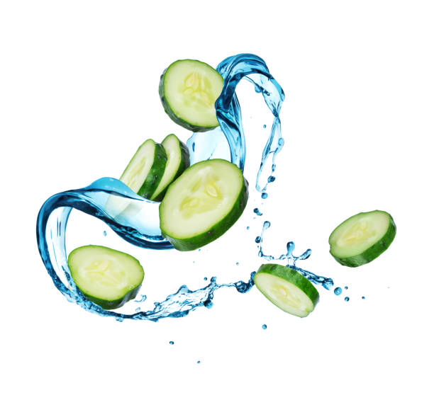 istock Sliced cucumbers with water splashes, isolated on a white background 1223056929