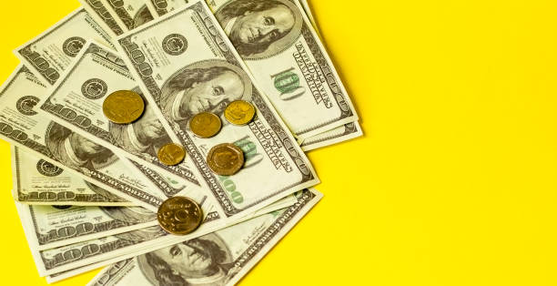 istock Bundle of money isolated on yellow background 1223056940