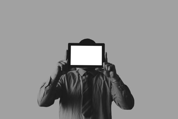 istock Man holding a tablet in hands. Screen instead of face. New technologies communication. Copy space place. Isolated on grey background. 1223060724