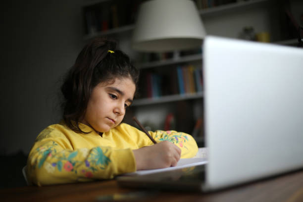 istock Schoolgirl watching online education class 1223061055
