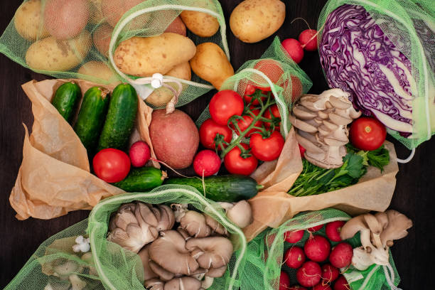 istock Vegetable in reusable bags on wood background, top view 1223061105