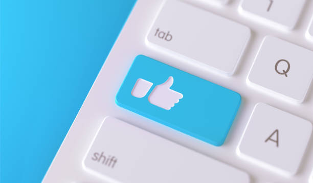 Thumbs up icon written on a blue button of a computer keyboard. Horizontal composition with selective focus and copy space. High angle view. Horizontal composition with copy space. Social media concept.