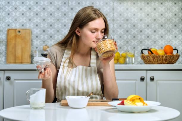 istock Young beautiful woman making fruit salad in kitchen 1223061941