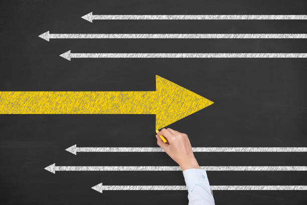 istock Going Your Own Way with Arrows Symbol on Blackboard Background 1223062160