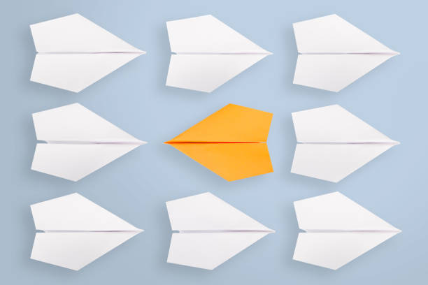 istock Change concepts with orange paper airplane leading among white 1223062274