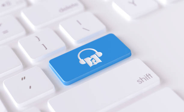 Audio book icon written on a blue button of a computer keyboard. Horizontal composition with selective focus and copy space. High angle view.