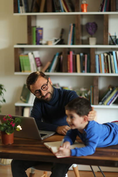 istock Fahter is showing his boy things on a laptop 1223062696