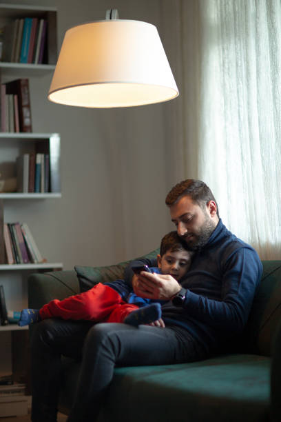 istock Happy dad and preschooler son relax on couch together 1223063883