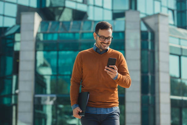 istock Online Business: Happy Businessman Working on the Street by Using his Smartphone 1223064145