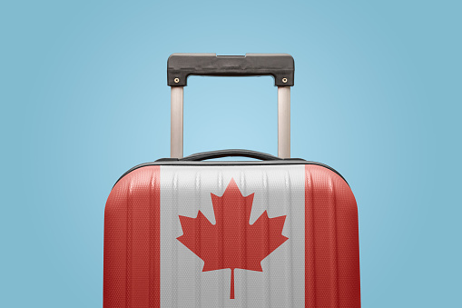 Suitcase with Canadian flag design travel America concept.