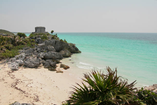 Archaeological ruins next to the caribbean sea, cloudless blue sky and turquoise waters