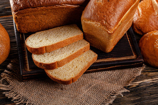 istock Assorted bread for catalan shooting. Long loaf, buns, baguette, pigtail, shaped. Bread on a wooden background. background image, copy space text 1223066839
