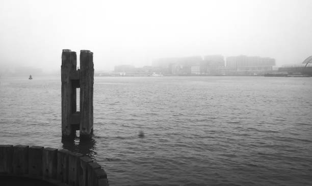 istock amsterdam harbour in the mist in black and white 1223067084