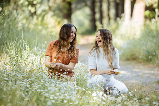 Two young women enjoying sunny day outdoors-Sisters