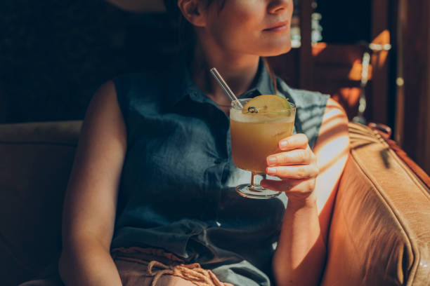 istock Woman Drinking a Delicious Lemonade at a Cosy Cafe 1223068119
