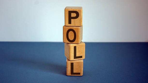 The word Vote on wooden cube block on blue table.