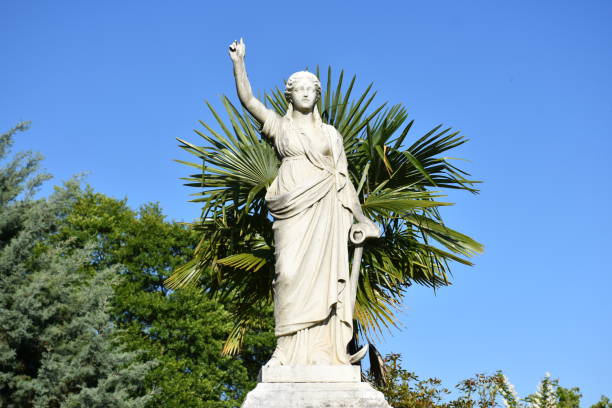 Statue of a woman at a cemetery gravesite