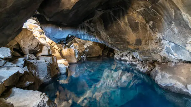 Volcanic cave Grjotagja with a incredibly blue and hot thermal water near lake Myvatn in the northeastern Iceland