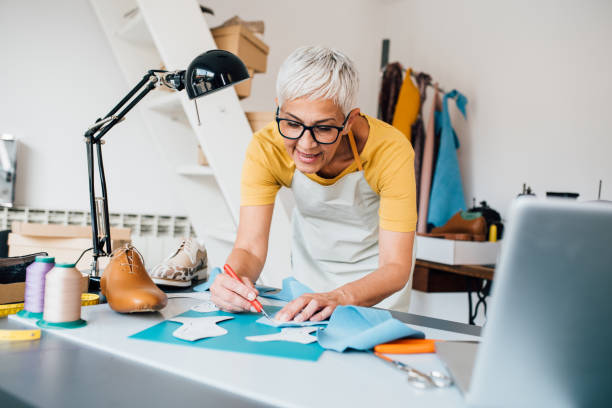 istock Mature shoemaker working on a new product 1223076159