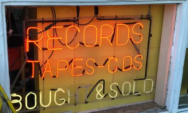 Cool vintage neon record store where records, tapes and cd’s are bought and sold