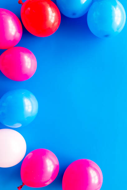 istock Decorative frame with colorful balloons on blue background top-down frame copy space 1223079494