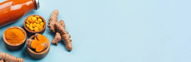istock Turmeric in different conditions: fresh, dry root, pills, powder and cut plant. 1223079656
