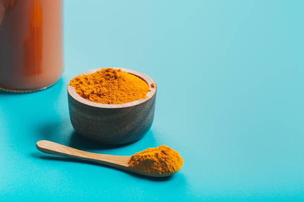 istock Turmeric in different conditions: fresh, dry root, pills, powder and cut plant. 1223079663
