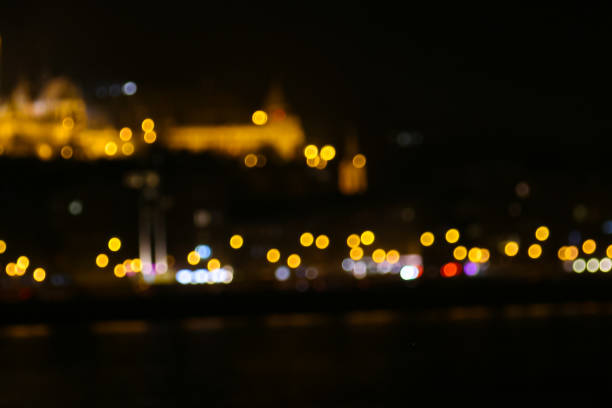 Bokeh city lights, traffic lights at night with defocused castle, seen in Budapest, capital of Hungary.