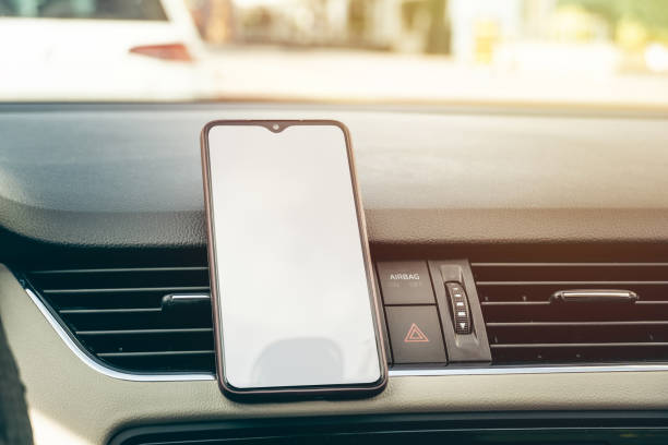 istock smart cell phone in the center car console with white blank screen 1223084126