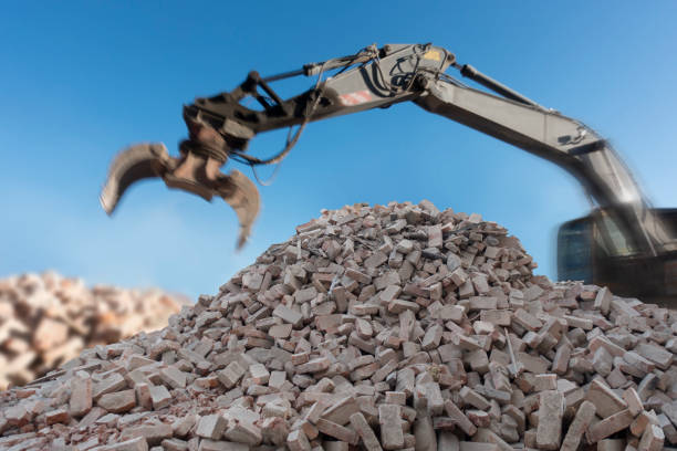 istock Heap of bricks at demolision site with scoop of digger 1223084248