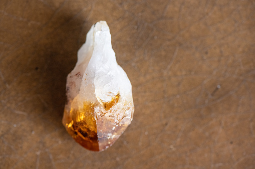 This is photograph of a raw citrine crystal point in natural sunlight.