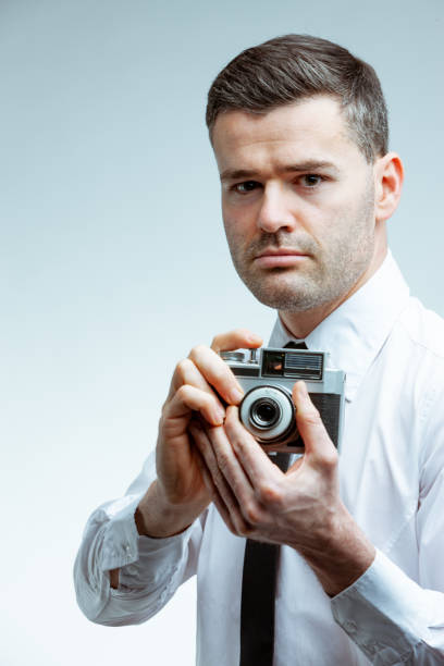 istock Portrait of a man with vintage camera 1223086578