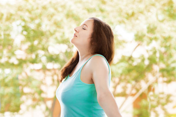 istock woman breathing fresh air outdoors in summer 1223088924