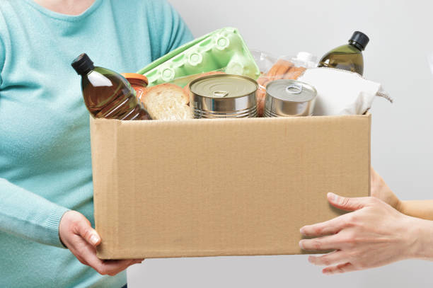 istock Volunteers with donation box with foodstuffs 1223088996