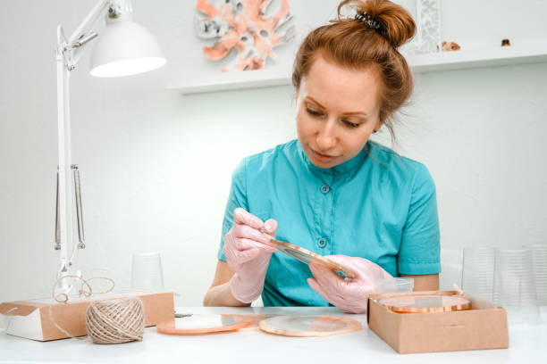istock Creativity and craft. A young girl creates coasters from resin. Gift wrapping. Decorative packaging. Idea for business. Remote work, work at home. Art coasters. 1223089241